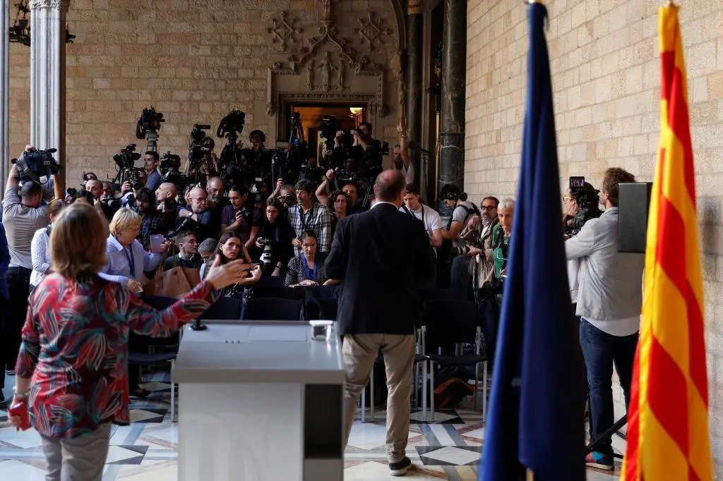 Reporters wait for the start of Catalan President Carles Puigdemont's statement at the regional government headquarters, in Barcelona, Spain, October 26, 2017. REUTERS/Rafael Marchante
