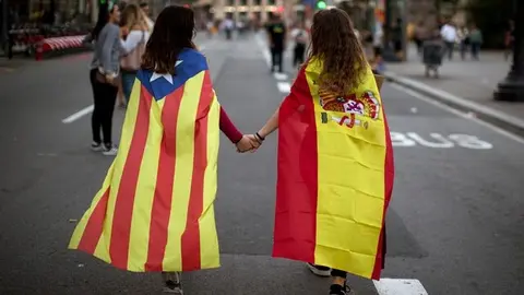 Dos chicas con banderas de Catalu&ntilde;a y Espa&ntilde;a cogidas de la mano. 

"El di&aacute;logo es la &uacute;nica opci&oacute;n para frenar la escalda del conflicto catal&aacute;n"
(Emilio Morenatti/AP)